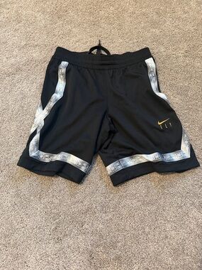 Nike Black Basketball Shorts with Silver Trim and Yellow Swoosh